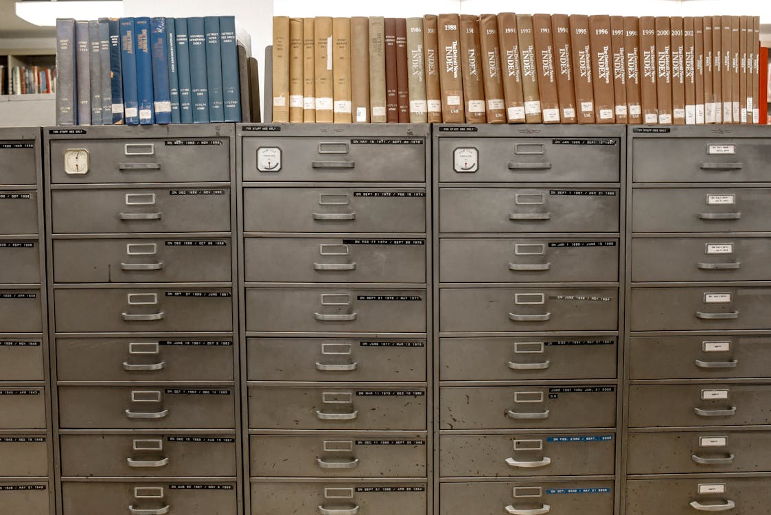 Steel filing cabinet drawer open with organized document folders ready for digitization